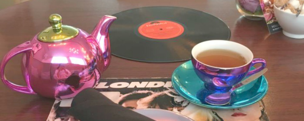 Tea table with cup and saucer and Blondie album cover at K - West