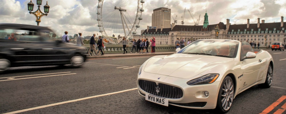 Cruising across London Bridge in a Maserati, County Hall and London Eye in the background