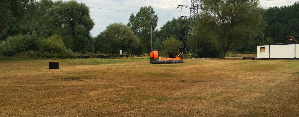 Maddie and Tom try out the hovercraft on the lawn at the hovercraft centre.