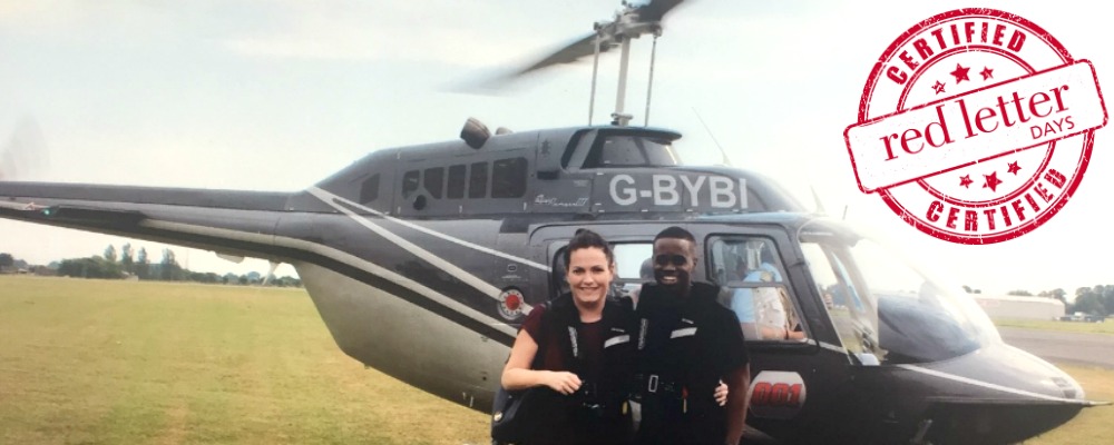 Lorraine and Marvin standing in front of the helicopter about to take them on a tour over London.