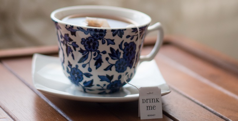 Tea bag brewing in blue and white tea cup