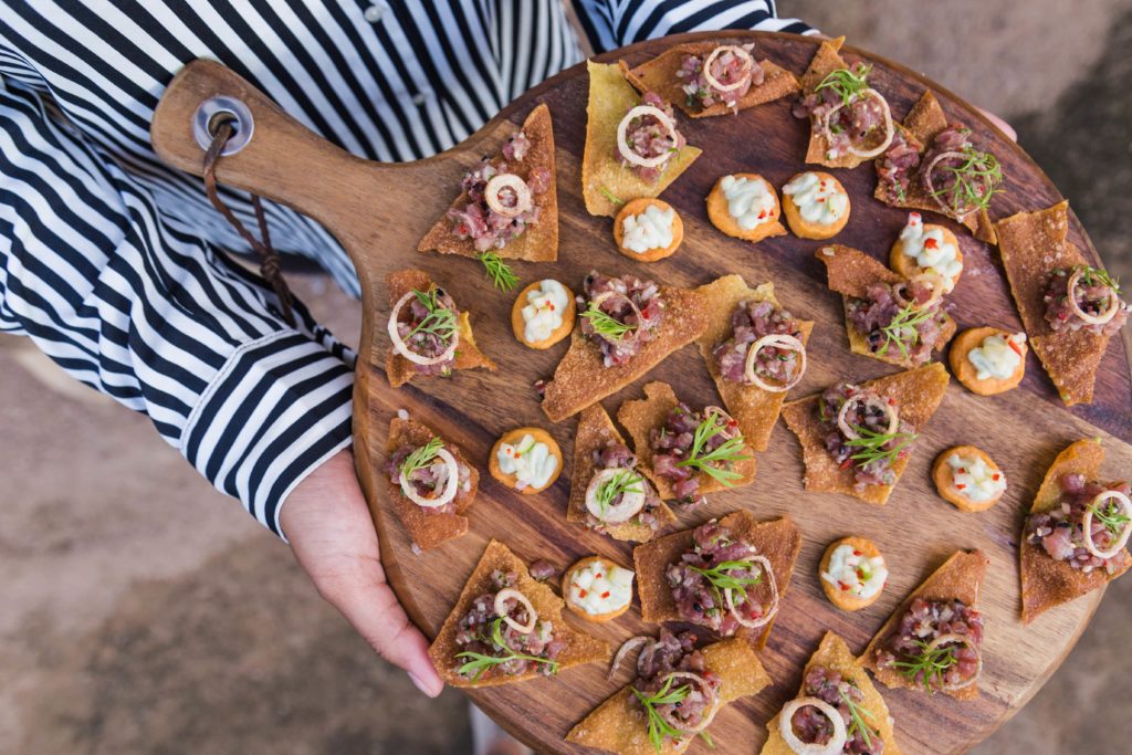 Woman holding a tray of canapes 