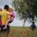 father and his kids in a field