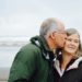older man kissing his wife on the cheek