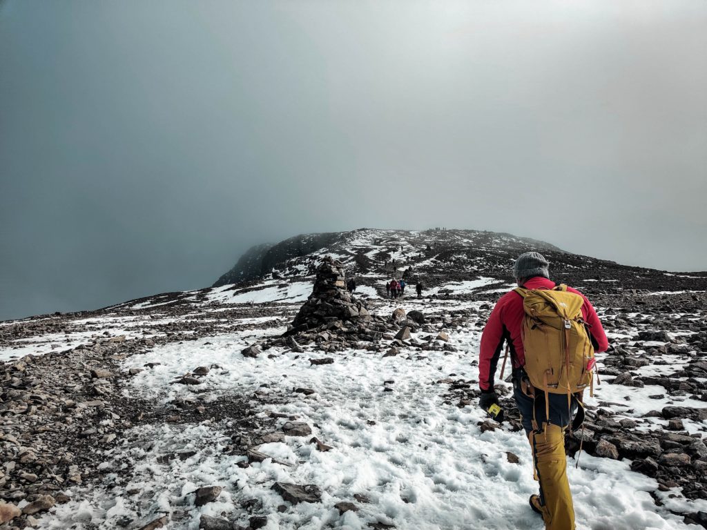 man walking up ben nevis mountain