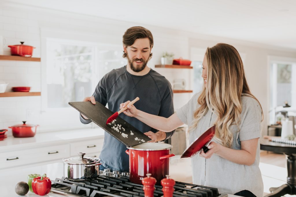 man and women cooking a meal