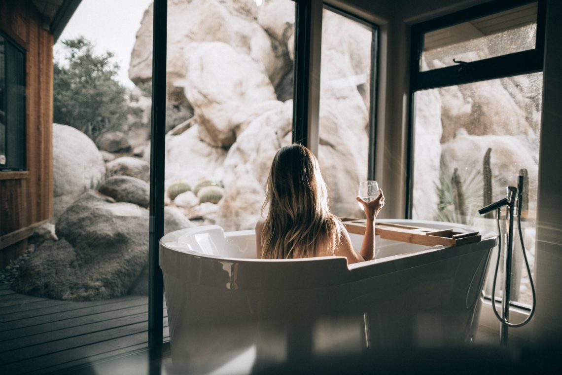 Women enjoying a glass of wine in a luxury bath