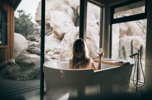 Women enjoying a glass of wine in a luxury bath